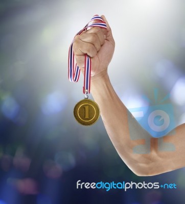 Hand And Gold Mmedal Stock Photo