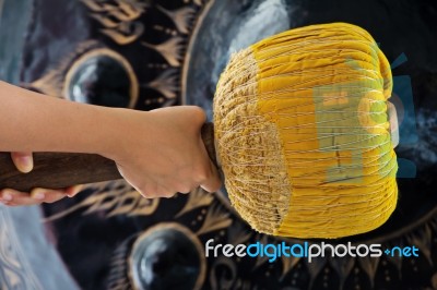 Hand Hit Big Gong In Temple Stock Photo