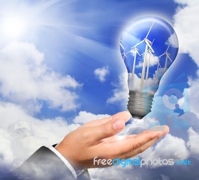 Hand Holding A Bulb With Turbines Stock Photo