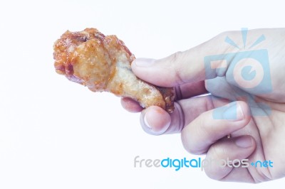 Hand Holding Grilled Chicken Wing Isolated On White Background Stock Photo