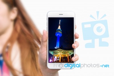 Hand Holding Smart Phone With Photo Of Seoul Tower Isolated On White Background Stock Photo