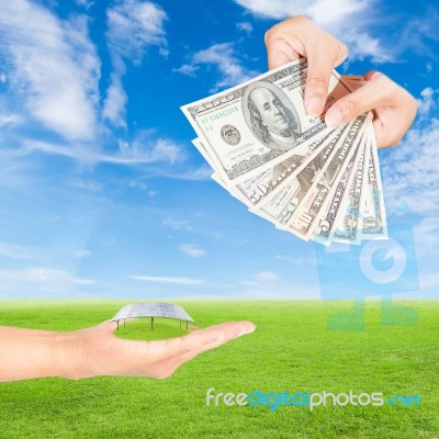 Hand Holding Solar Panels And Us Dollars Banknote Stock Photo