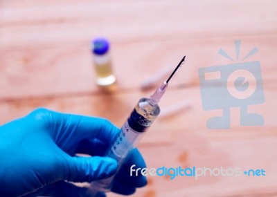 Hand Holding Syringe With  Needle Stock Photo