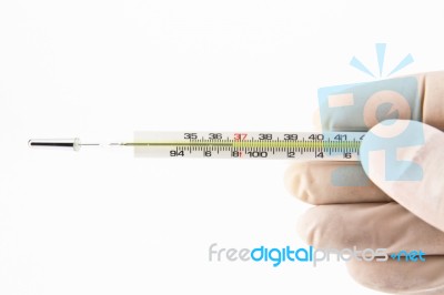 Hand Holding Thermometer Stock Photo