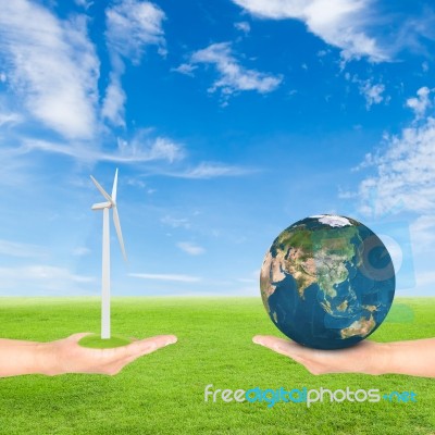 Hand Holding Wind Turbine And Earth Stock Photo
