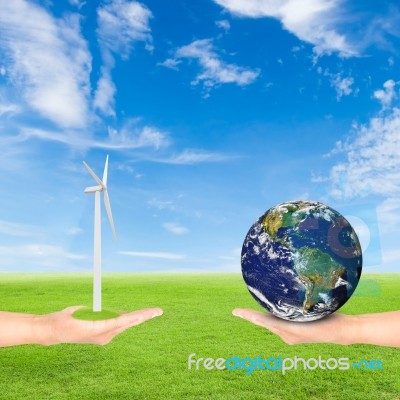 Hand Holding Wind Turbine And Earth Stock Photo