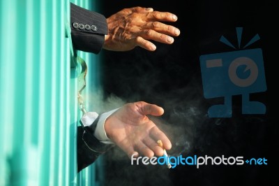 Hand Of Business Man Smoking Cigarette In Jail With Black Backgr… Stock Photo