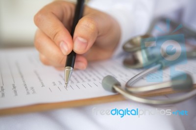 Hand Of Doctor Writing On Prescription Stock Photo