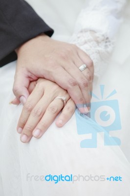 Hand Of Groom And Bride Warming Holding With Wedding Daimond Ring Stock Photo