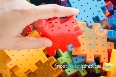 Hand On Jigsaw Puzzle Game Stock Photo