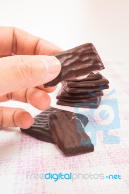 Hand On Peppermint Chocolate Piece Stock Photo