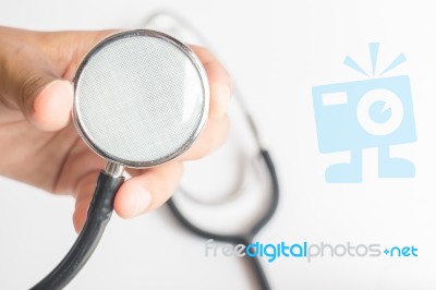 Hand On Stethoscope On White Background Stock Photo