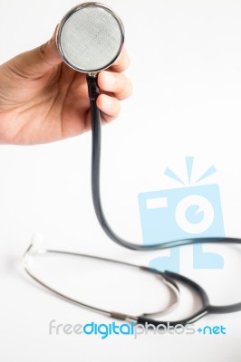 Hand On Stethoscope On White Background Stock Photo