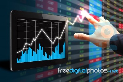 Hand Pointing Graph On Tablet Pc Stock Photo