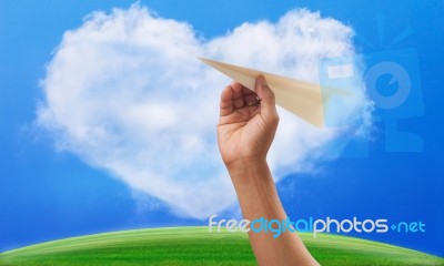 Hand Preparing To Throwing Paper Plane To Mid Air Againt Green G… Stock Photo