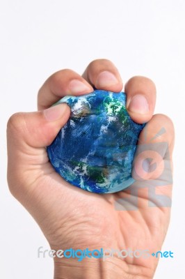 Hand Squeezing Earth Stock Photo