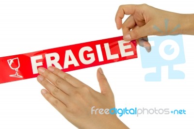Hand Stick Red Fragile Tape Stock Photo