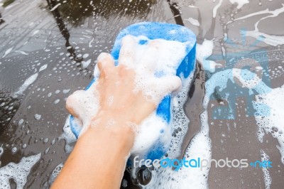 Hand Washing Brown Car With Blue Sponge And Bubbles Stock Photo