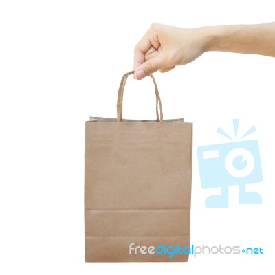 Hand With Paper Shopping Bag Isolated On White Stock Photo