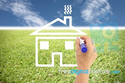 Hands Are Painted House On Grass And Blue Sky Stock Photo