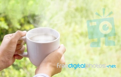 Hands Hold Big Cup Of Hot Black Coffee In Happily Morning Relax Stock Photo