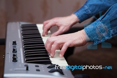 Hands Of The Musician On The Keyboard Synthesizer Closeup Stock Photo