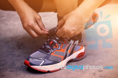 Hands Tying Shoes For Jogging Stock Photo