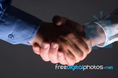 Handshake Handshaking In Dark With Low Light Stock Photo