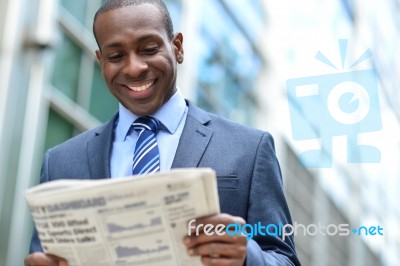 Handsome African Man Reading A Newspaper Stock Photo Handsome African Man Reading A Newspaper Stock Photo