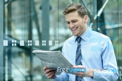 Handsome Businessman Reading A Newspaper Stock Photo