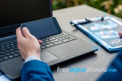 Handsome Businessman Wearing Suit And Using Modern Laptop Outdoo… Stock Photo