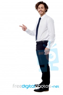 Handsome Executive Pointing Away Stock Photo