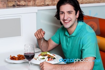 Handsome Guy Enjoying His Meal Stock Photo