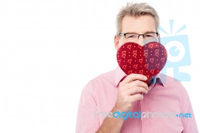 Handsome Man Holding Heart Shape Gift Box Stock Photo