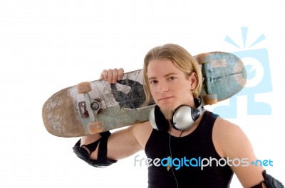 Handsome Man Holding Skateboard Stock Photo