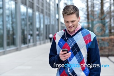 Handsome Man Listening To Music At Outdoors Stock Photo