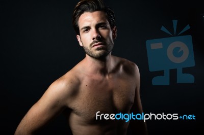 Handsome Muscular Male Model Posing Over Black Background Stock Photo