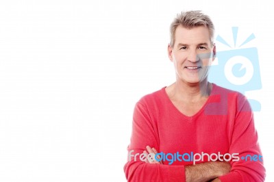 Handsome Senior Man Posing With Arms Folded Stock Photo