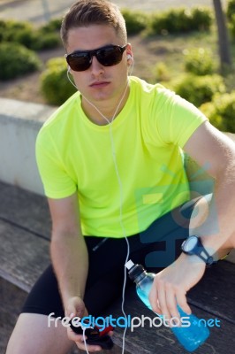 Handsome Young Man Listening To Music After Running Stock Photo