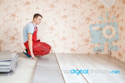 Handyman Laying Down Laminate Flooring Boards Stock Photo