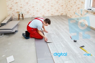 Handyman Laying Down Laminate Flooring Boards Stock Photo