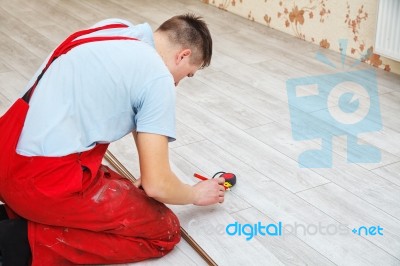 Handyman Laying Down Laminate Flooring Boards Stock Photo