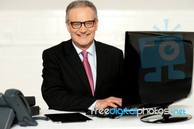 Happy Aged Corporate Man Typing On Keyboard Stock Photo