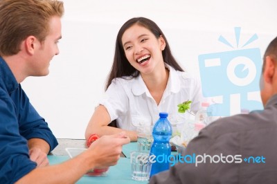 Happy Asian Woman Eating Food With Her Friends Stock Photo