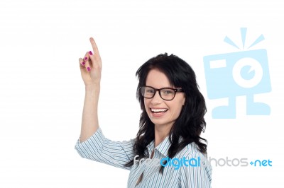 Happy Brunette In Eyeglasses Gesturing Upwards Stock Photo Happy Brunette In Eyeglasses Gesturing Upwards Stock Photo