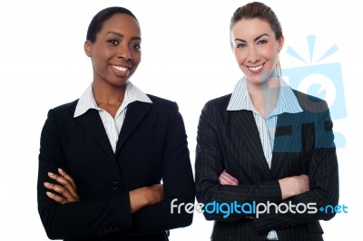 Happy Businesswomen With Arms Crossed Stock Photo