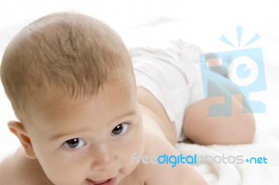 Happy Child Lying And Looking At Camera Stock Photo