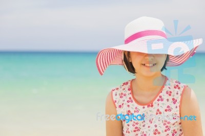 Happy Child Relaxing On The Beach Against Sea And Sky Background… Stock Photo