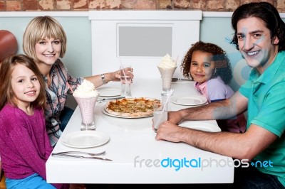 Happy Family Enjoying Dinner Stock Photo