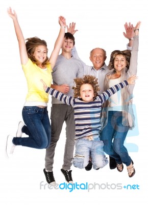 Happy Family Jumping High Stock Photo